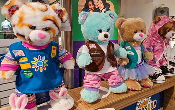 build a bear display with four bears in Girl Scout outfits