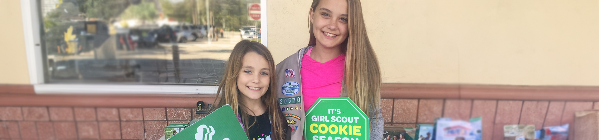  two girls at a cookie booth 